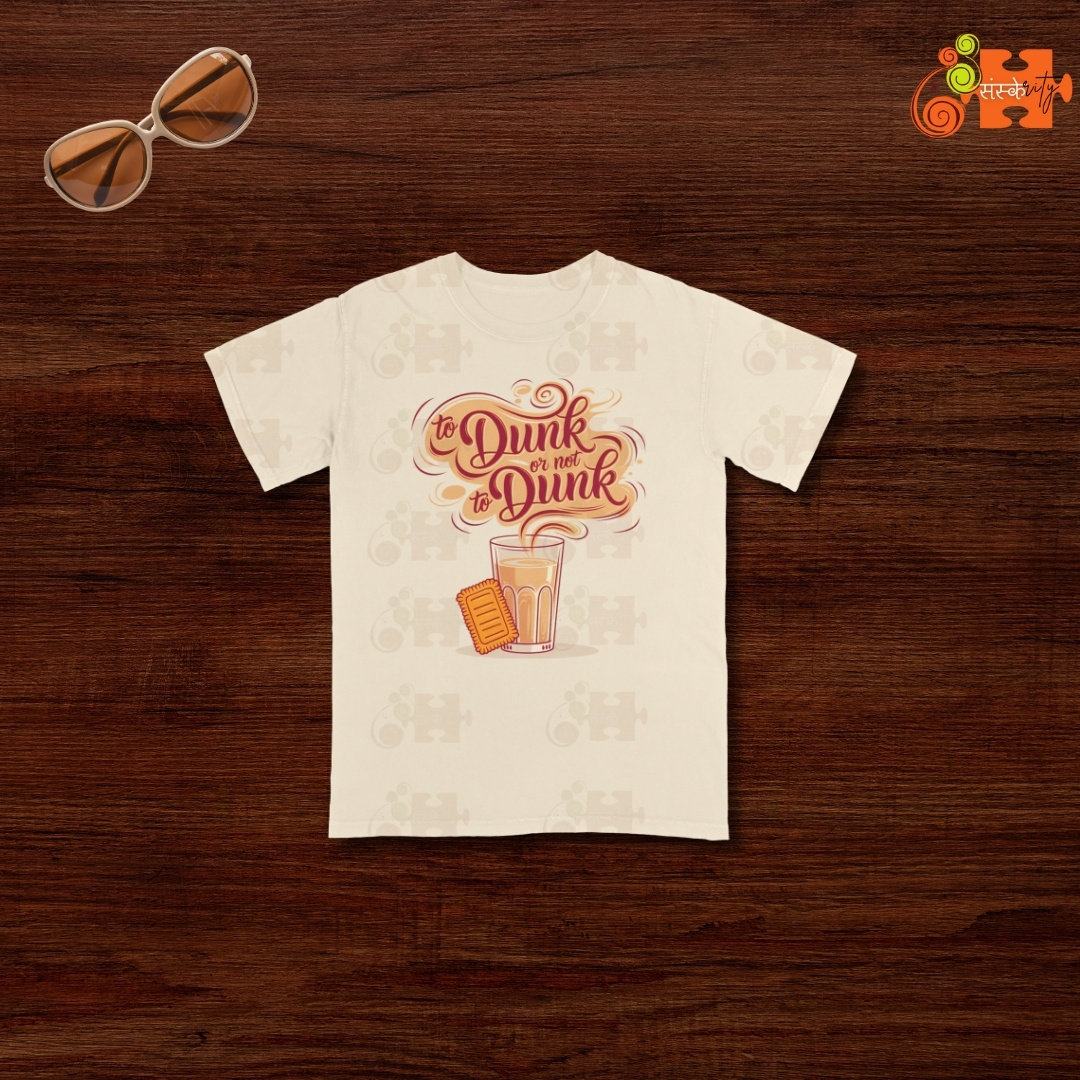 Front view of an ivory (or cream) t-shirt featuring a graphic of a chai glass with a biscuit and the text 'Dunk or Not Dunk'.